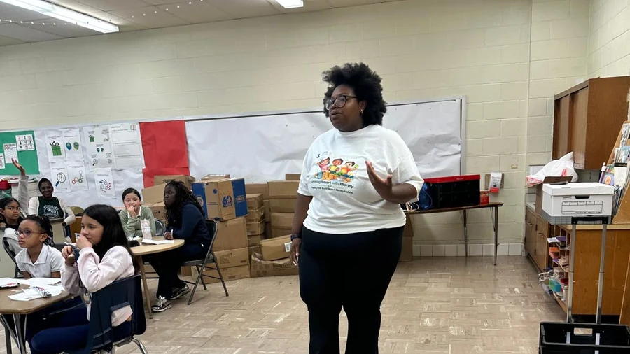 Dr. Bridget Kaspa presenting the Little Crowns Confidence Programme to a classroom of students during a school workshop