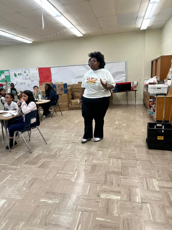 Dr. Bridget Kaspa presenting the Little Crowns Confidence Programme to a classroom of students during a school workshop